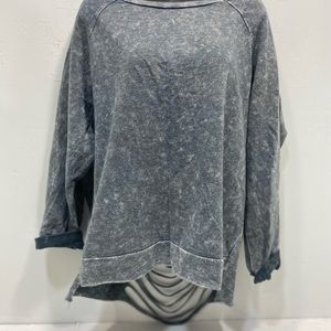 Super cute distressed sweater with cutouts in the back